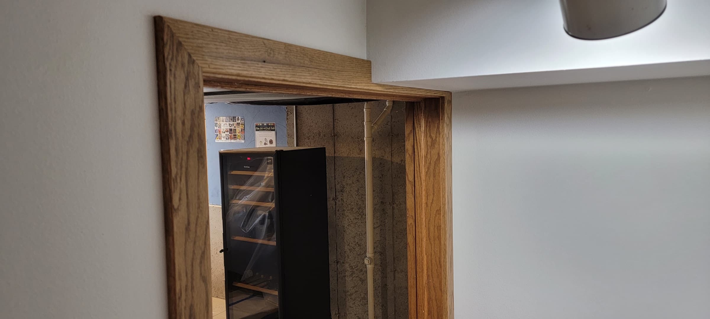 Custom wood door casing and trim around a basement doorway